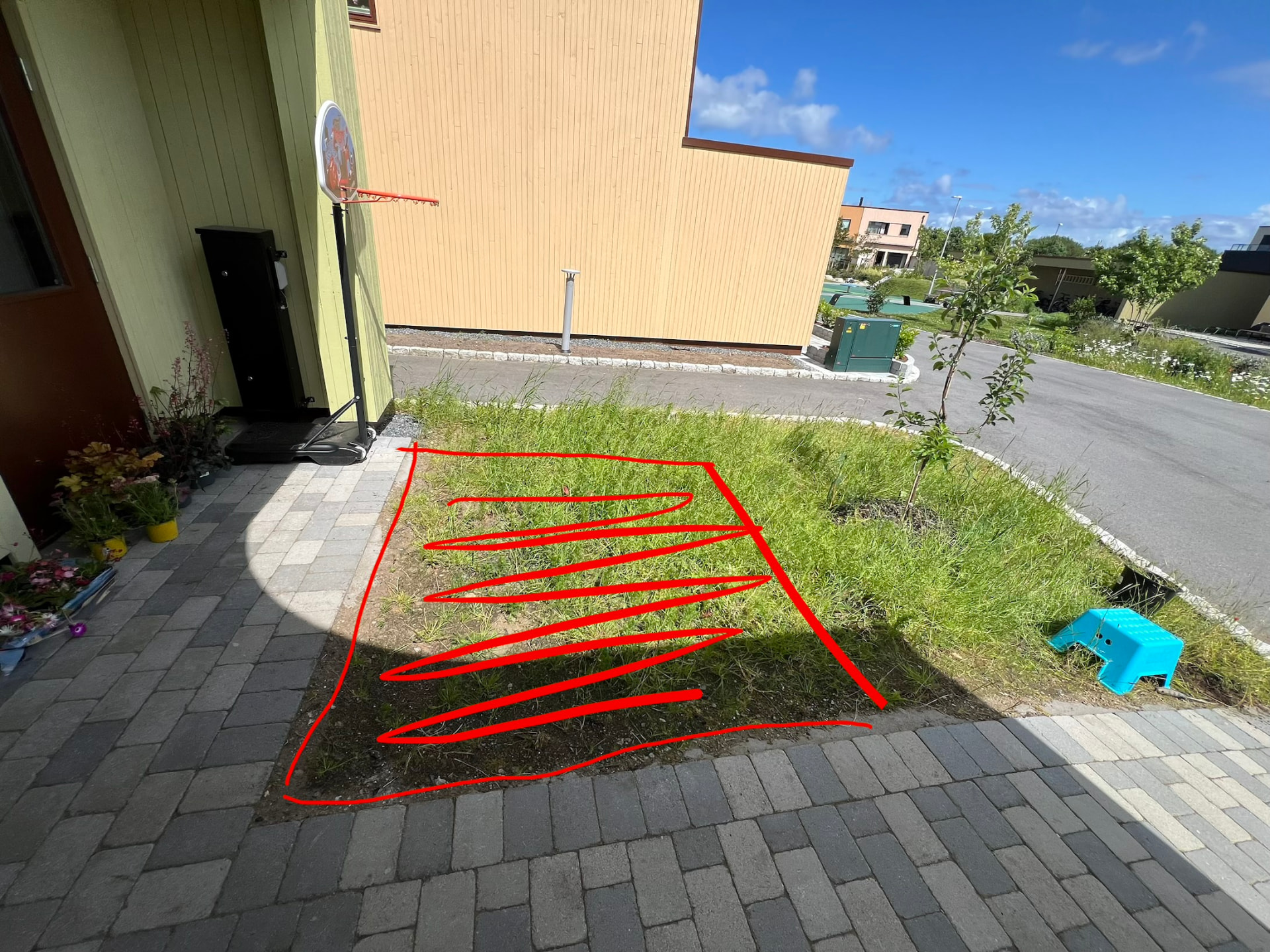Uteplassen før utvidelsen, med markert gressfelt mellom eksisterende belegningsstein og bed